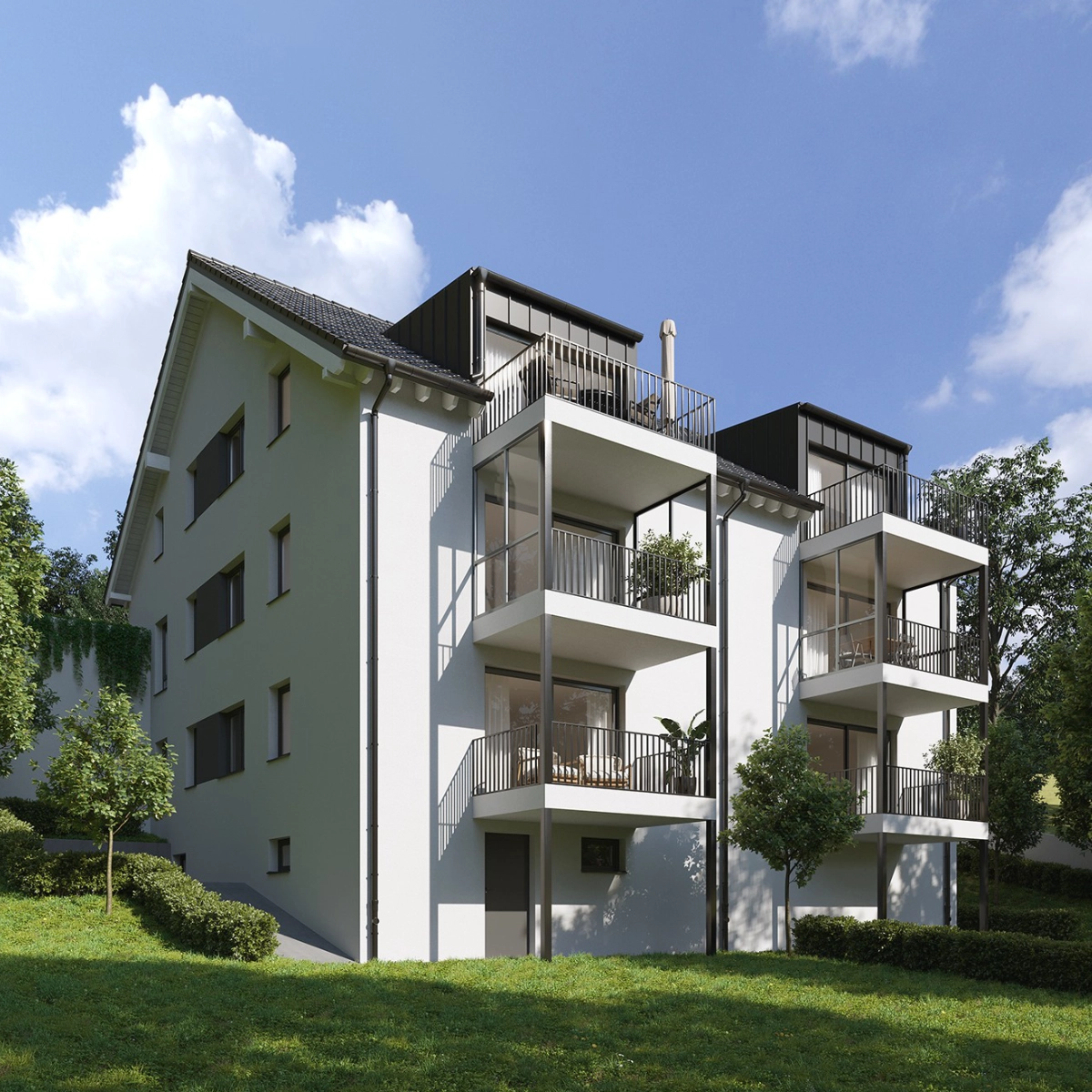 Neubau eines Mehrfamilienhauses mit Balkonen, umgeben von Grün
